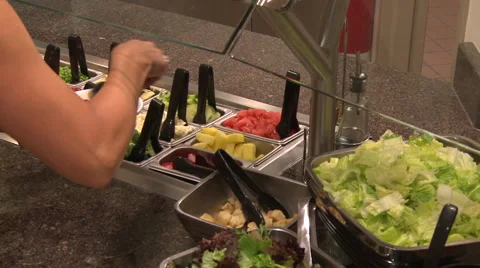 Hands getting salad from salad bar Vídeo Stock 55878990