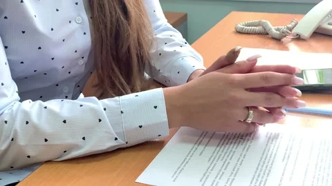 Hands of a girl in a light blouse with a light manicure and a gold ring close-up Stock Footage 160913055