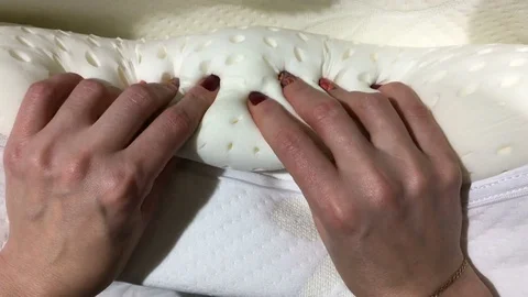 Hands of the girl squeeze a pillow from memory foam. Stock Footage 84850657