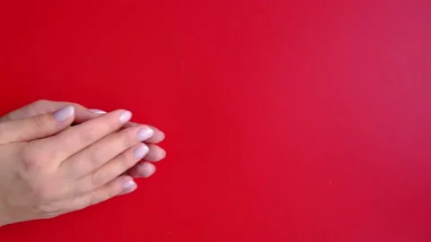 Hands give a gift. Layout on a red background. the concept of the holiday. Video stock 165866218