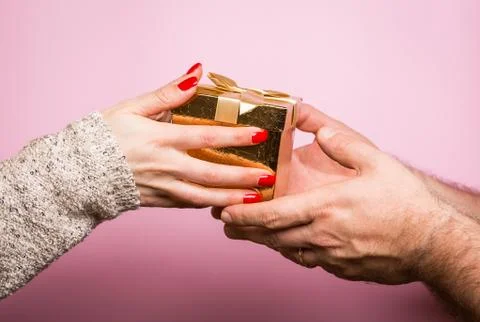 Hands giving and receiving a present Stock Photos