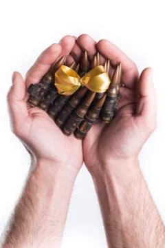Hands giving bullets on white background Stock Photos