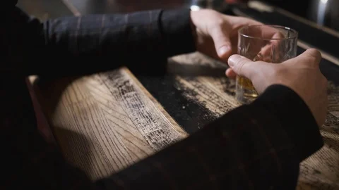 Hands with glass on bar,glass rolling on table,man at bar,concept alcohol Stock Footage 129800519
