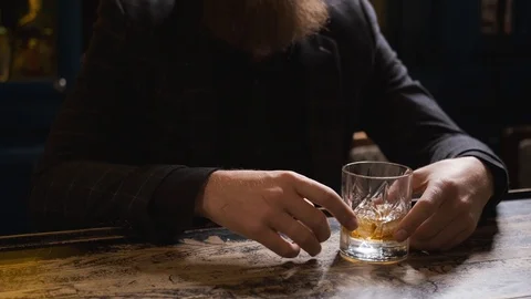 Hands with glass on bar,glass rolling on table,man at bar,concept alcohol Stock Footage 129800569