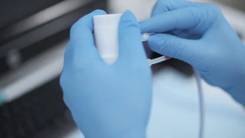 Hands in gloves assembling medical equipment Stockbeeldmateriaal 314115306