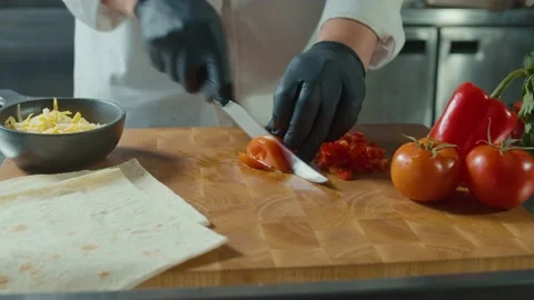 Hands in Gloves of Cook Chopping Tomato on Wooden Board. Healthy Food. Stock Footage 196259366