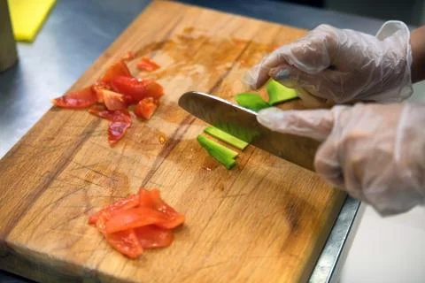 Hands in gloves cut vegetables Stock Photos