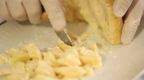 Hands with gloves cutting Parmesan cheese 스톡 동영상 47212179