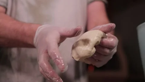 Hands in gloves kneading dough for baking Stock Footage 291274899
