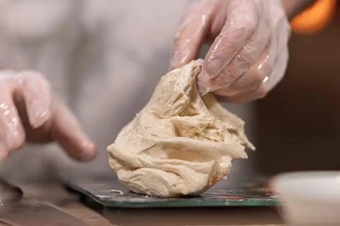 Hands in gloves kneading dough for baking Stock Photos