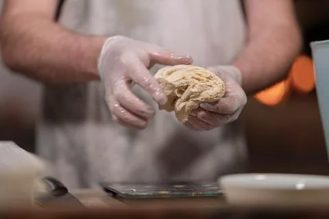 Hands in gloves kneading dough for baking 스톡 사진
