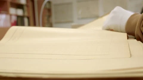 Hands gloves leaf through paper documents table. Puts a page in document. Video stock 230914449