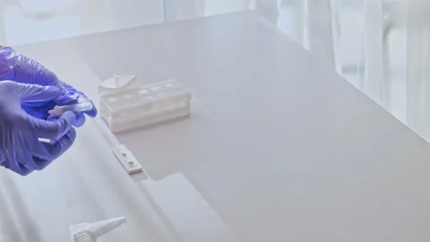 Hands in gloves makes a covid-19 antigen pcr express test Stock Footage 165070905