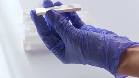 Hands in gloves makes a covid-19 antigen pcr express test Stock Footage 165070979