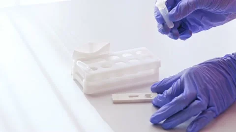 Hands in gloves makes a covid-19 antigen pcr express test Stock Footage 165071145