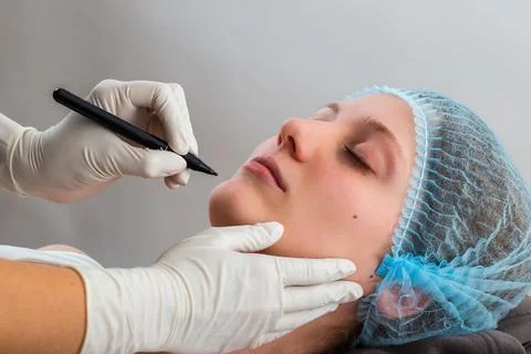 Hands in gloves marking procedure before plastic surgery Stock Photos