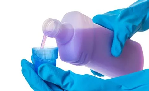 Hands in gloves pour a detergent Stock Photos