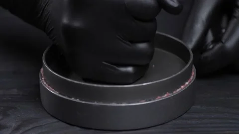 Hands in gloves press on the burger press. Forming a hamburger. Video stock 228648825