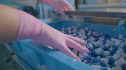 Hands in gloves put in a box a lot of tubes of medicine Stock Footage 111609356