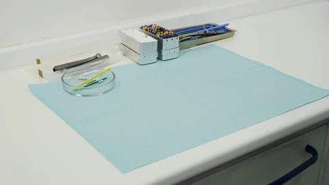 Hands in the gloves put on the table a dental mirrors, mask and excavators. Stock Footage 83622759