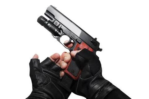 Hands in gloves reloading gun. Stock Photos