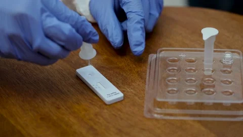 Hands with gloves taking a buffer tube with culture sampling and applying som Stock Footage 145540163