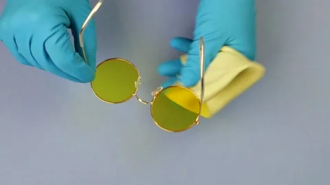 Hands in gloves wipe sunglasses. Stock Footage 231362341