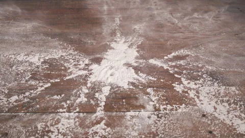 Hands going back and forth smacking a pile of flour on a table in slow motion. Stock Footage 309006235