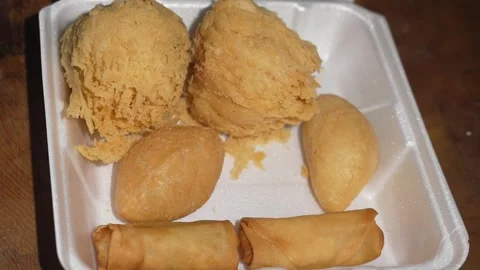 Hands grab assorted fried dim sum from styrofoam take out box Stock Footage 251830077