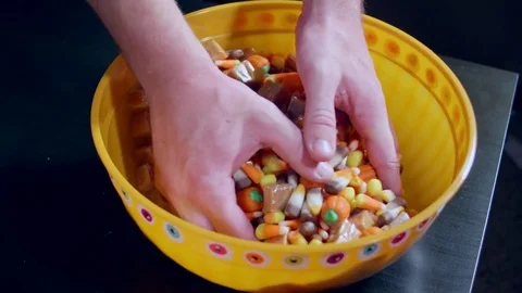 Hands Grabbing Halloween Candy and dropping it Stock Footage 80724395