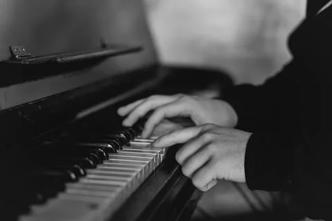 Hands gracefully playing the piano, capturing the essence of music, creativity Stock Photos