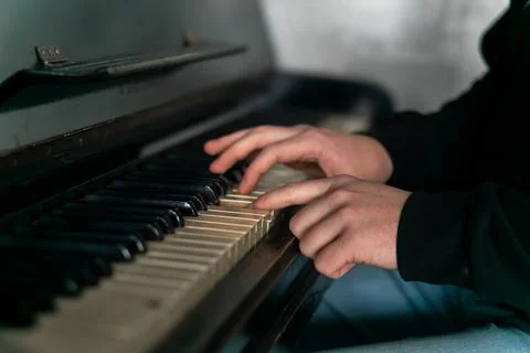 Hands gracefully playing the piano, capturing the essence of music, creativity Stock Photos