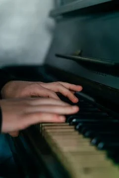 Hands gracefully playing the piano, capturing the essence of music, creativity Stock Photos
