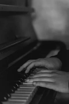 Hands gracefully playing the piano, capturing the essence of music, creativity Stock Photos