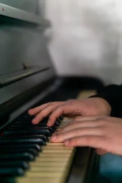 Hands gracefully playing the piano, capturing the essence of music, creativity Stock Photos