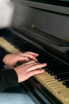 Hands gracefully playing the piano, capturing the essence of music, creativity Stock Photos