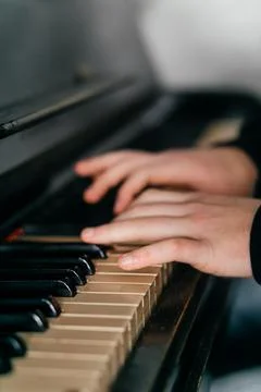Hands gracefully playing the piano, capturing the essence of music, creativity Stock Photos