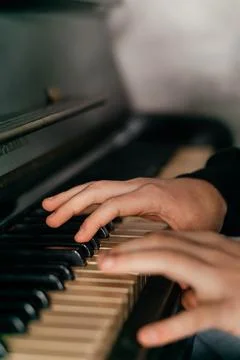 Hands gracefully playing the piano, capturing the essence of music, creativity Stock Photos