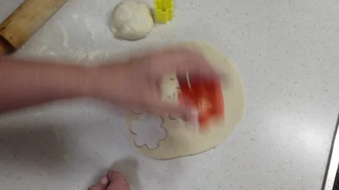 Hands of granny cutting cookie dough with shaped cookie cutters. Stock Footage 238026024
