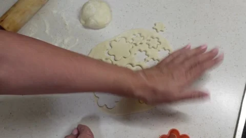 Hands of granny cutting cookie dough with shaped cookie cutters. Stock Footage 238026025