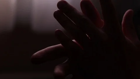 Hands Grasping in Dramatic Dark Lighting. Devout Faithful Person Praying. Stock Footage 115314236
