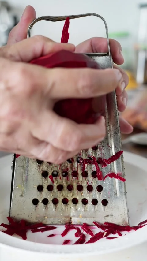 Hands Grate Beets, Beetroot Rasped Into White Bowl With Juice, Red Shreds Stock Footage 323626593