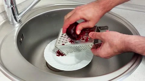Hands Grate Raw Beetroot into Plate in Clean Stainless Sink Setup Video stock 321049165