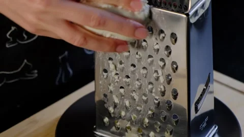 Hands Grating Cheese on Electric Appliance in Cooking Kitchen Video stock 341416742