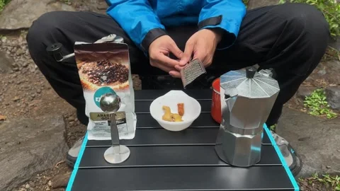 Hands Grating Fresh Ginger Root on Portable Table, Outdoor Cooking Close-Up Video stock 324850783