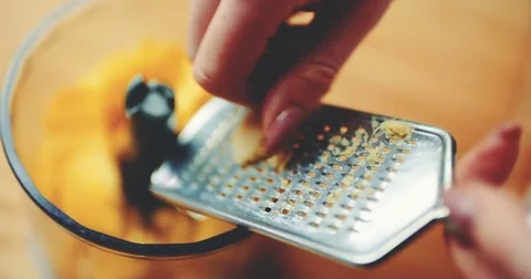 Hands Grating Ginger On Mango Pieces In Mixer Video stock 73211220