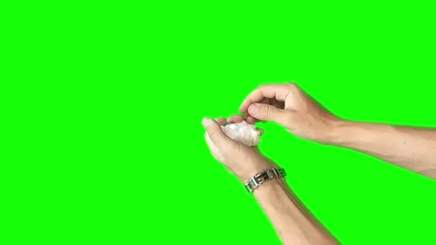 Hands on a green background crumpled a sheet of paper and straightened it back Stock Footage 280441454