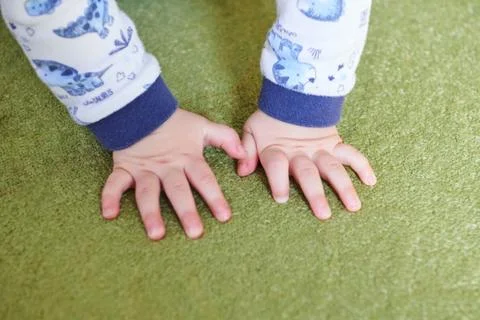 Hands on green carpet Stock Photos