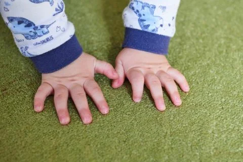 Hands on green carpet Stock Photos