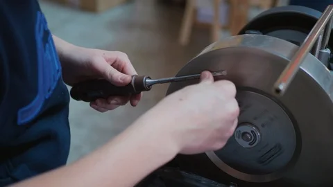 Hands grind detail, bench grinder or rough grinding machine Stock Footage 104283784